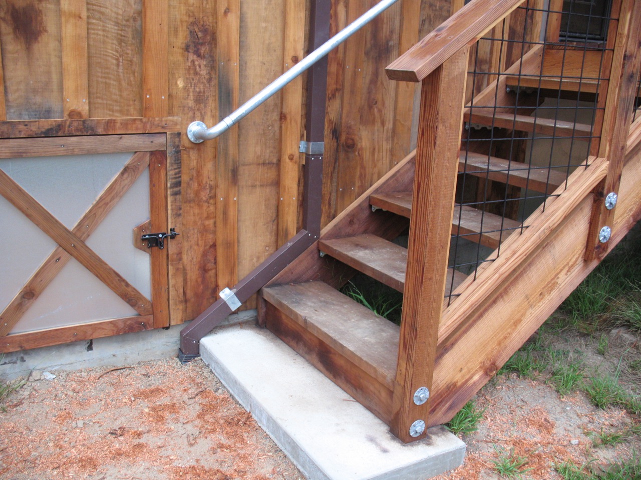 Stairway landing, railing, downspout detail