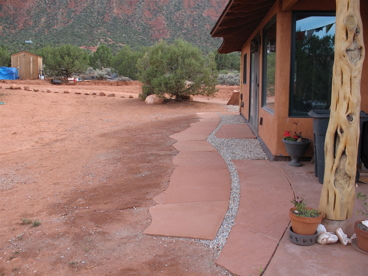 Red sandstone walkway and gravel drip line